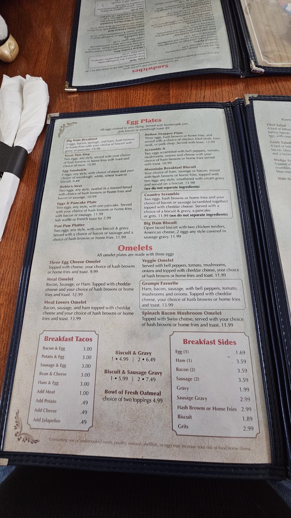 Restaurant menu showing eggs, shrimp, and chicken dishes.